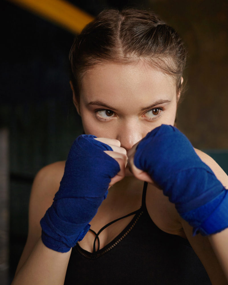 Sports Fighting Training Physical Exercise Concept Indoor Shot Concentrated Young Caucasian Woman Wearing Top Handwraps Clenching Fists 2048X1365